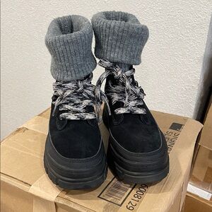 UGG Ashton Hiker Boots in black suede with a gray knit cuff.